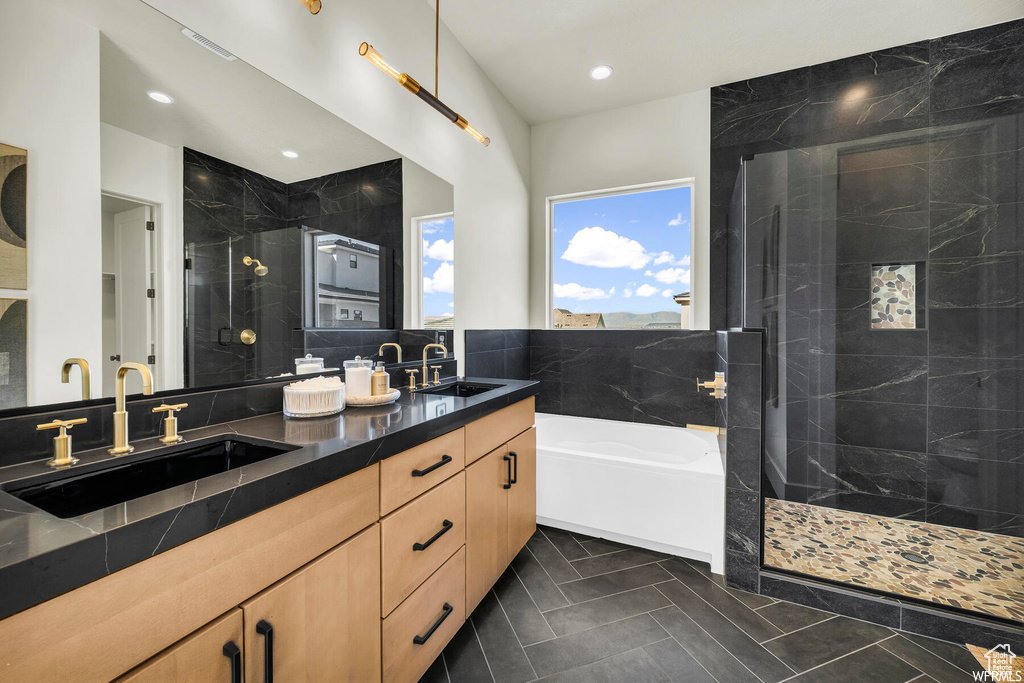Bathroom with a stall shower, double vanity, a garden tub, tile patterned flooring, and recessed lighting