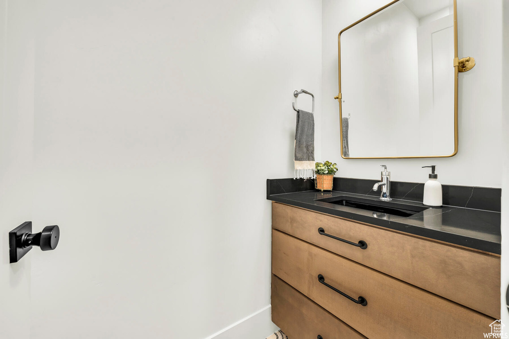 Bathroom featuring vanity and baseboards