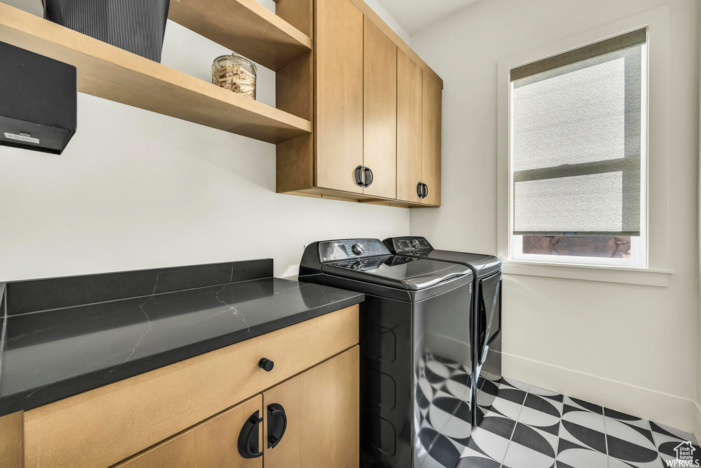 Washroom with washer and dryer and cabinet space