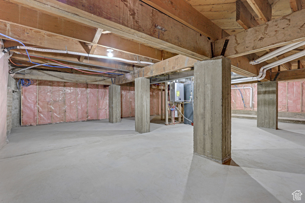 Unfinished basement featuring tankless water heater