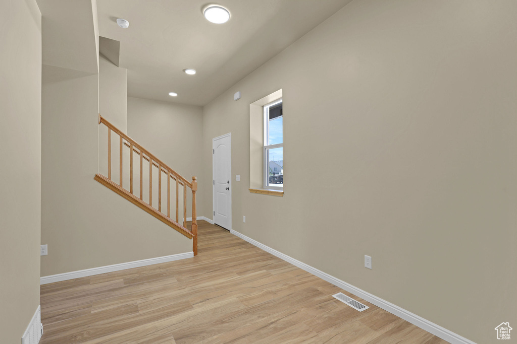 Entryway featuring light wood-style floors, stairway, and recessed lighting