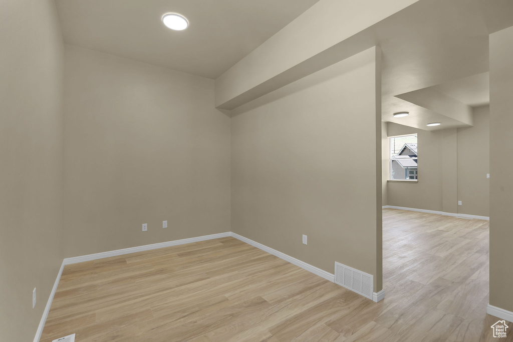 Empty room featuring light wood finished floors and baseboards