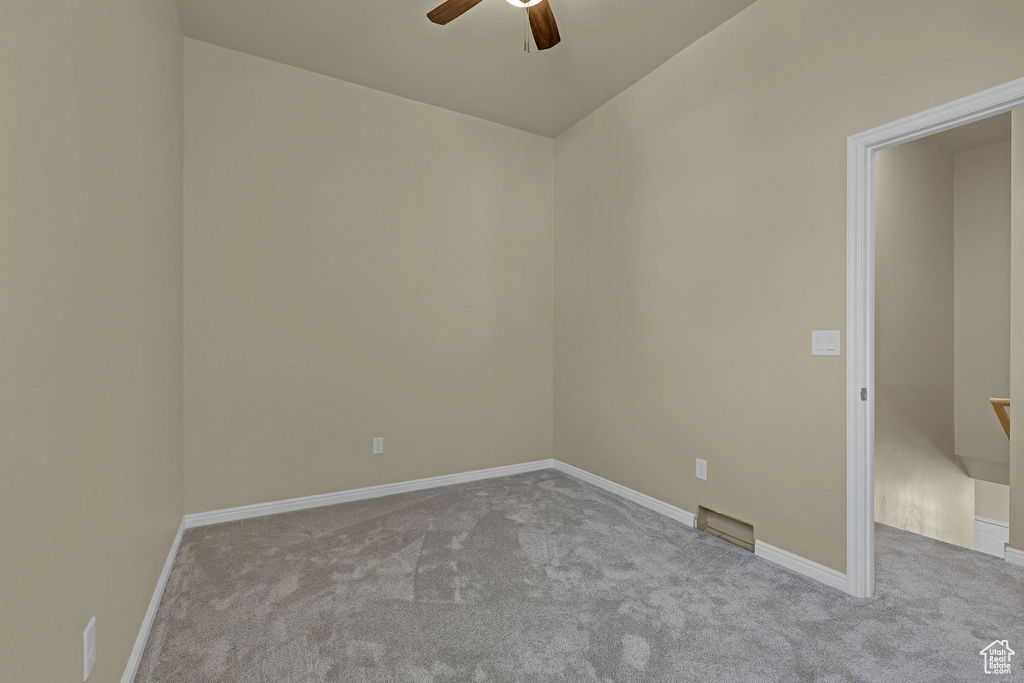 Unfurnished room featuring carpet and ceiling fan
