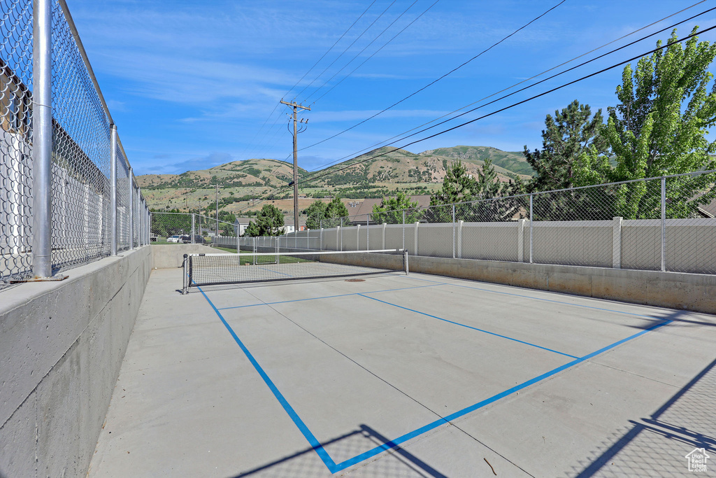 View of tennis court with a mountain view