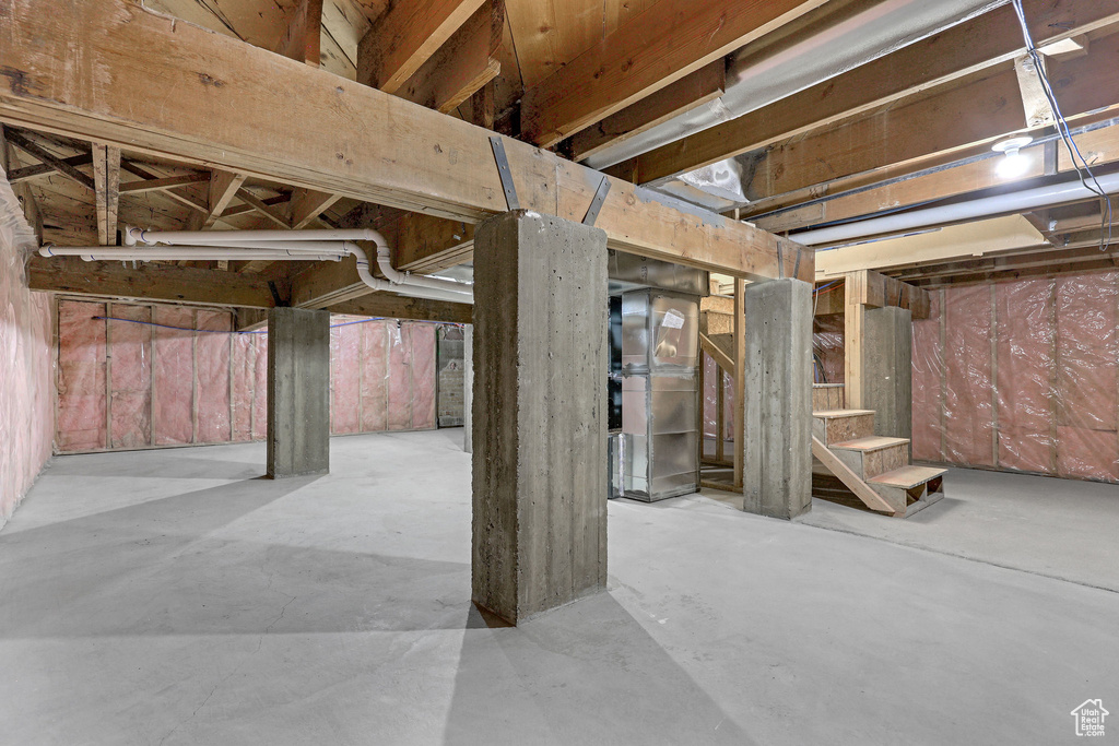 Unfinished basement featuring stairs