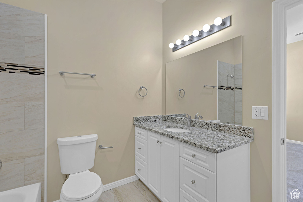 Bathroom with vanity, a shower, marble finish floors, and a bathtub