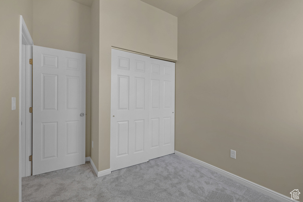 Unfurnished bedroom featuring carpet and a closet