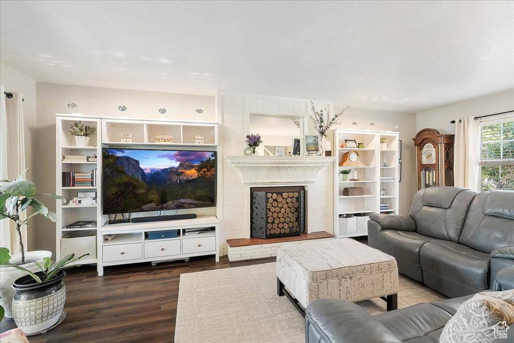 Living room with wood finished floors and a fireplace