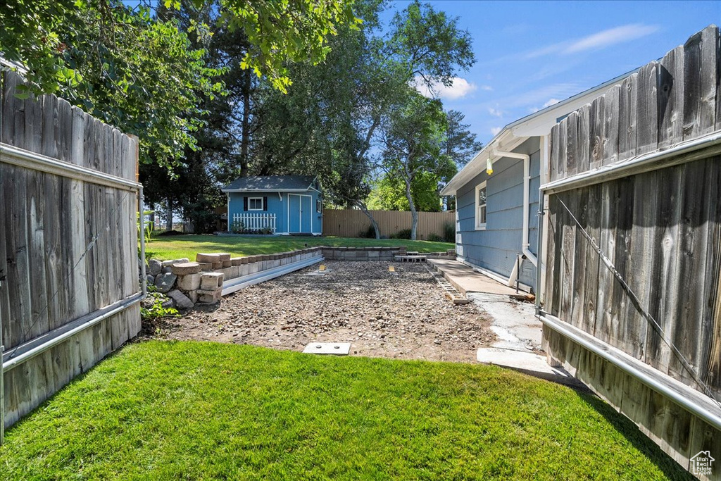 Fenced backyard with a storage unit