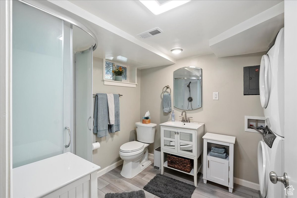 Full bath with vanity, an enclosed shower, and wood finished floors
