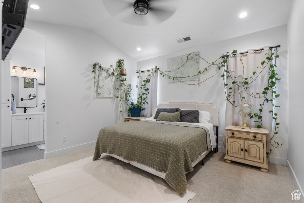 Bedroom with recessed lighting, light colored carpet, connected bathroom, lofted ceiling, and ceiling fan