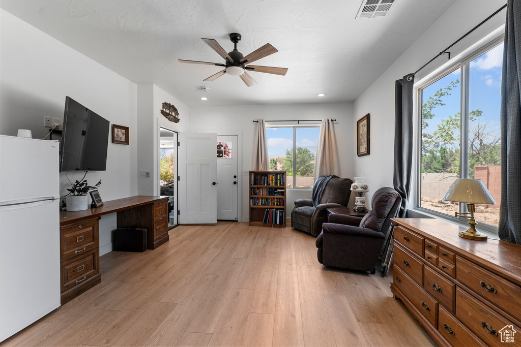Living room featuring ceiling fan, light wood-style flooring, an office area, and recessed lighting