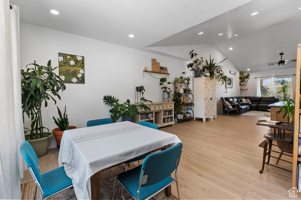 Dining space featuring vaulted ceiling, light wood-type flooring, a ceiling fan, and recessed lighting