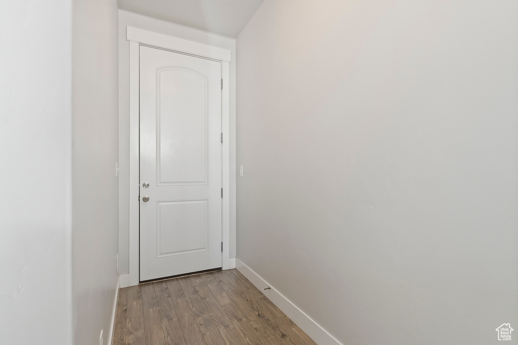 Corridor with wood finished floors and baseboards