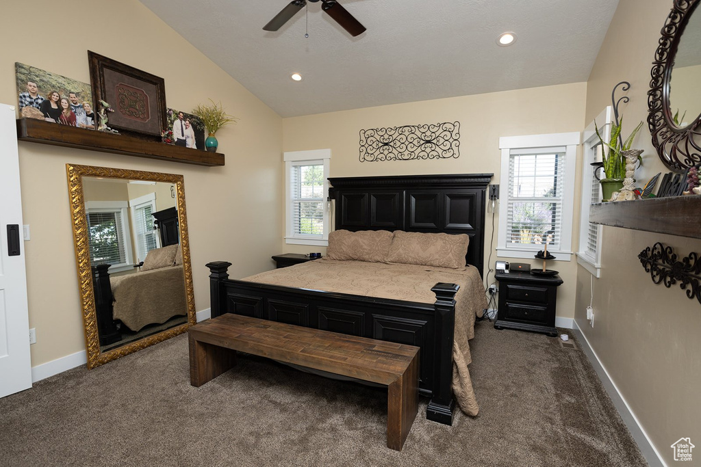 Bedroom featuring dark colored carpet, lofted ceiling, multiple windows, recessed lighting, and a ceiling fan