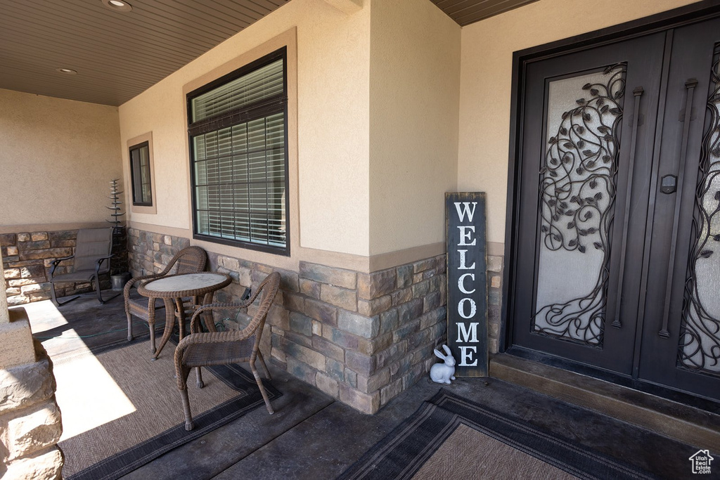 View of exterior entry featuring stucco siding and stone siding