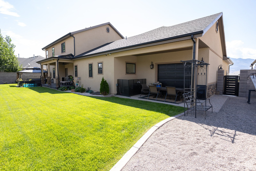 Back of house with stucco siding and a patio area