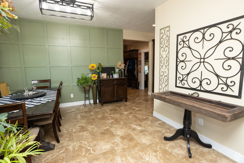 Dining area featuring a decorative wall and baseboards