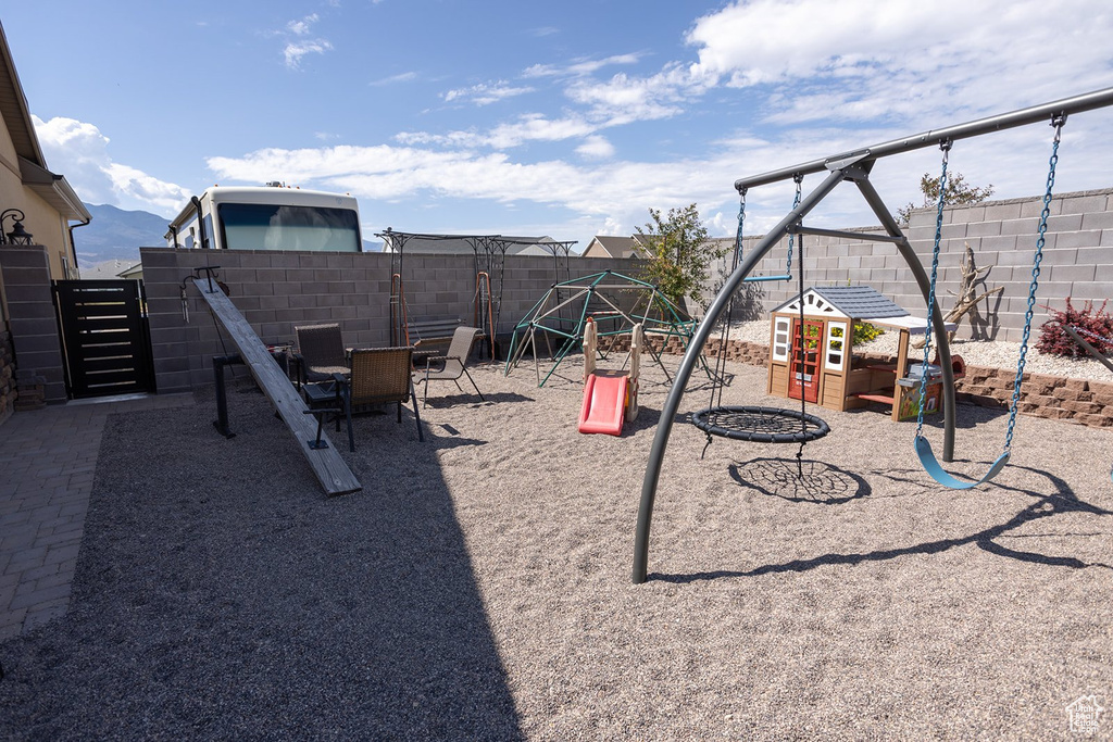 View of playground featuring a fenced backyard