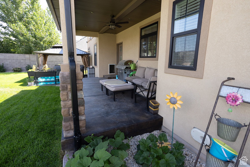 View of patio featuring a gazebo, ceiling fan, and a grill