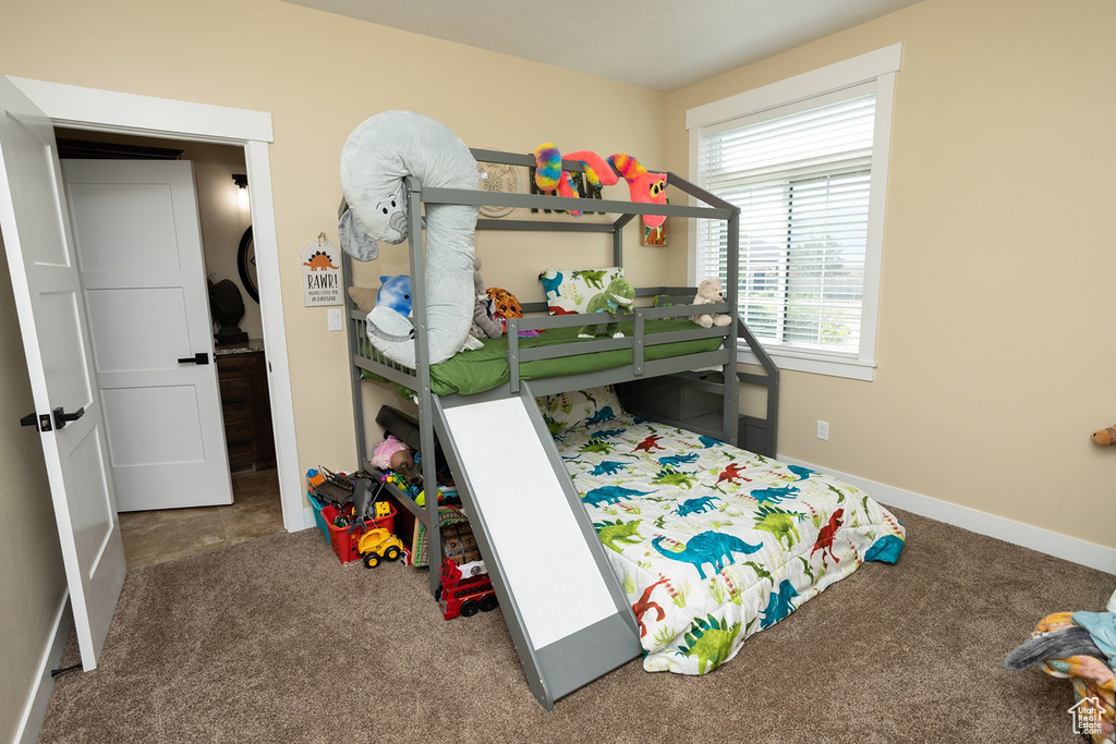 Bedroom with carpet floors and baseboards
