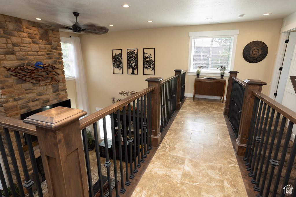 Corridor with an upstairs landing and recessed lighting