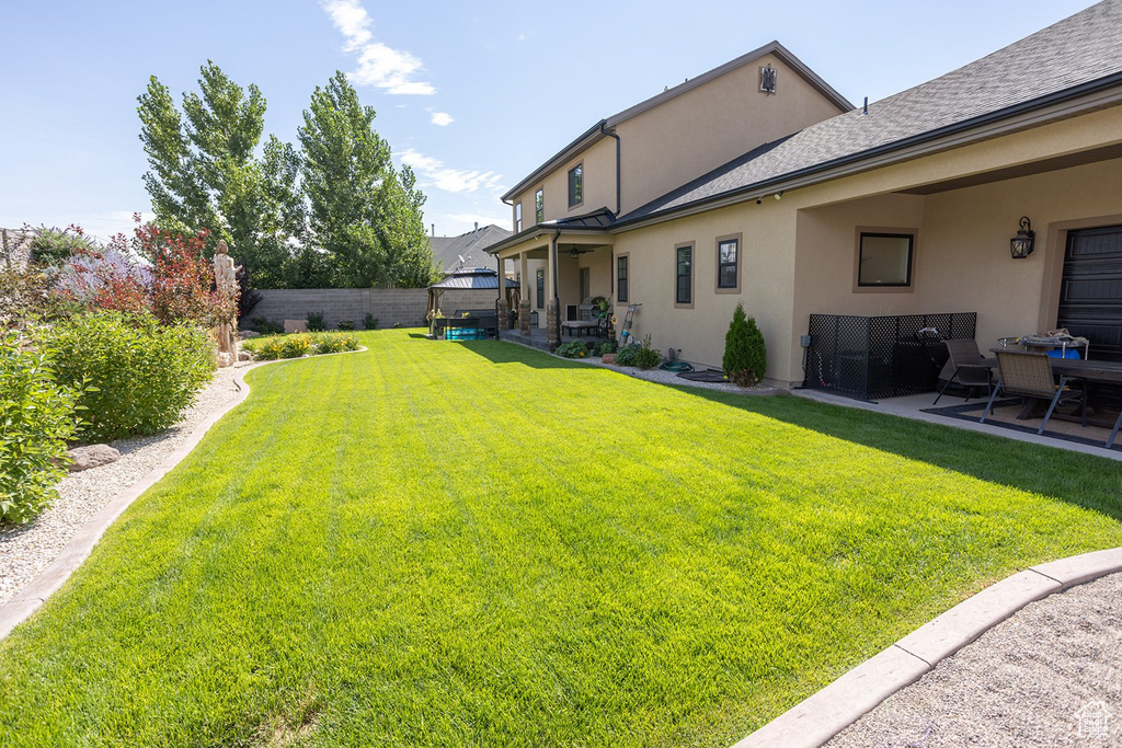 Fenced backyard featuring a patio