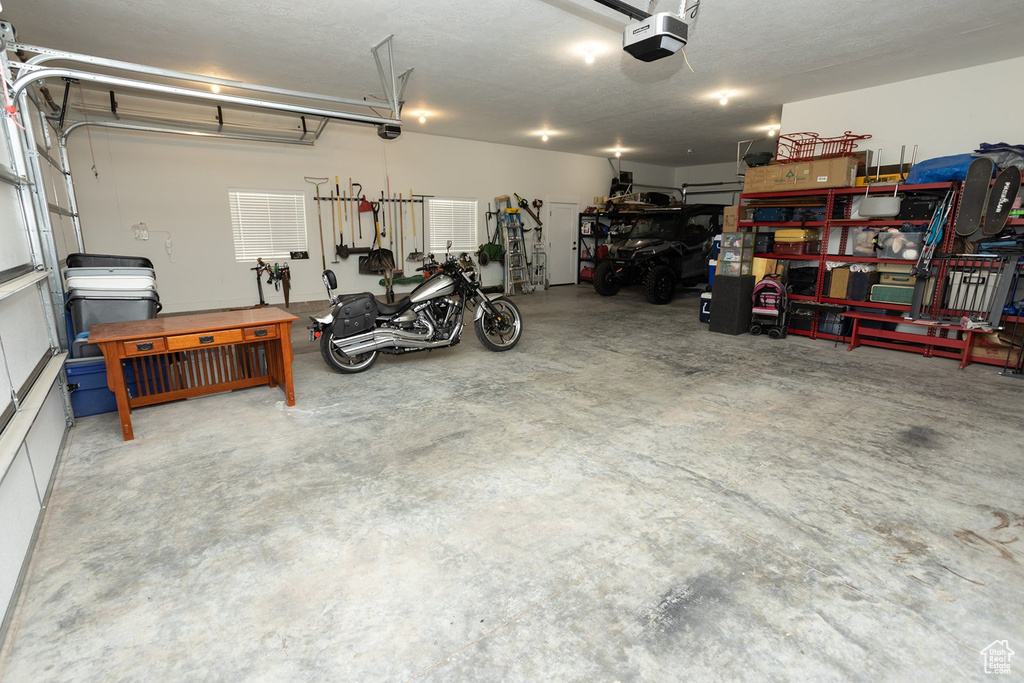 Garage with a garage door opener and a workshop area