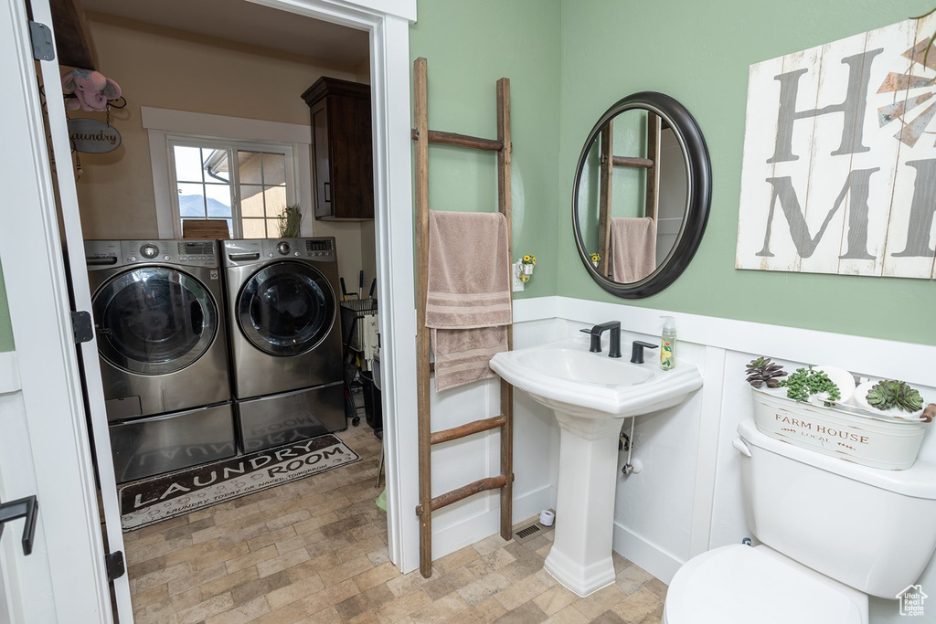 Bathroom with independent washer and dryer and toilet