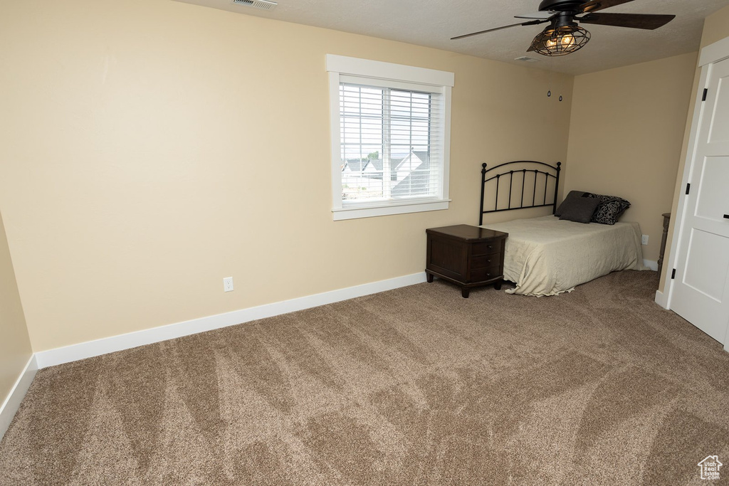Bedroom featuring carpet and a ceiling fan