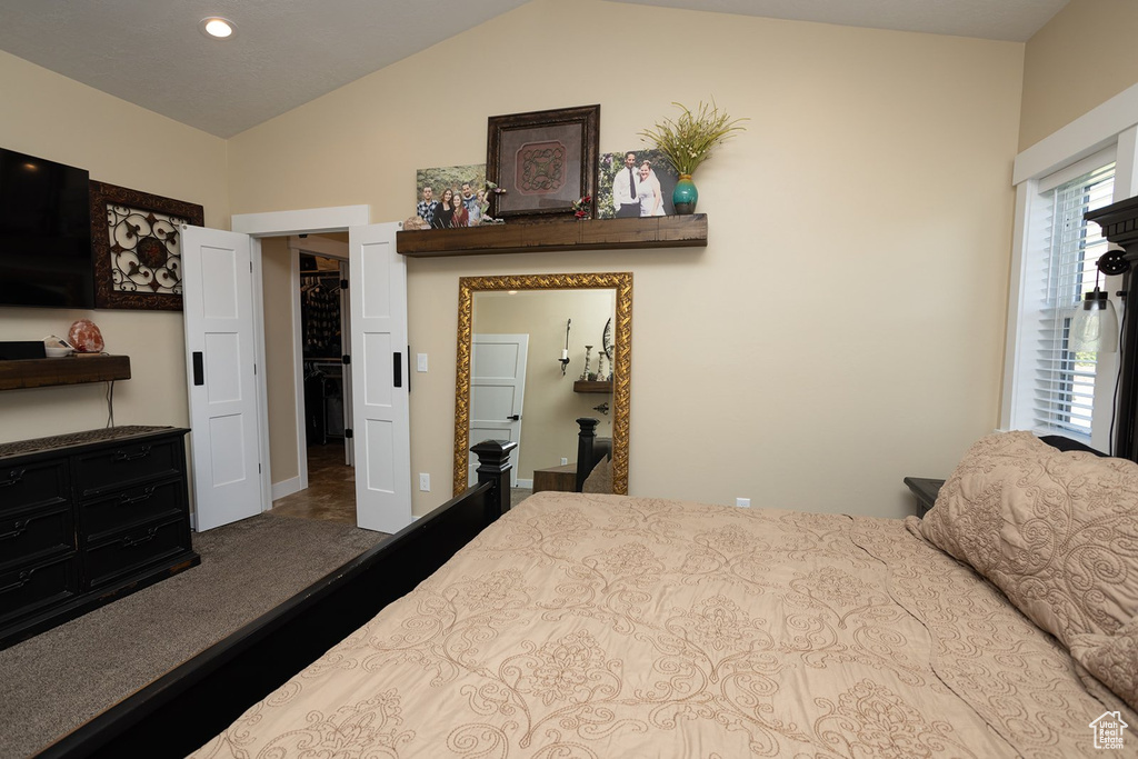 Bedroom with lofted ceiling and recessed lighting