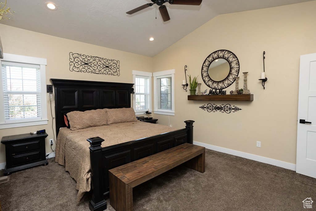 Carpeted bedroom featuring vaulted ceiling, multiple windows, recessed lighting, and ceiling fan