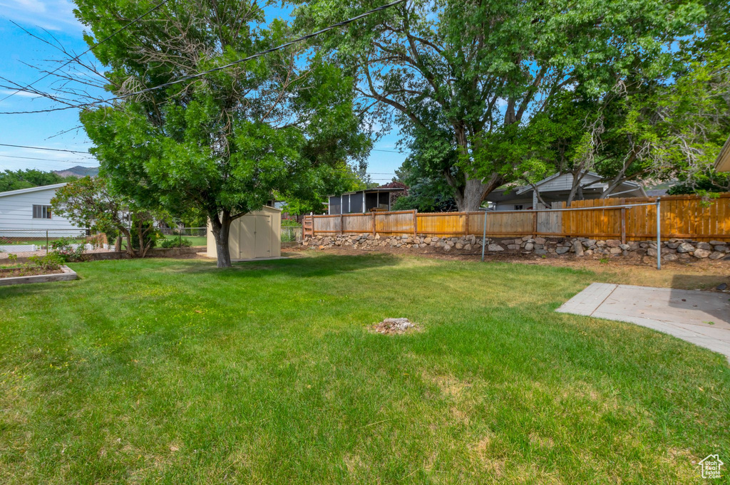 Fenced backyard with a shed