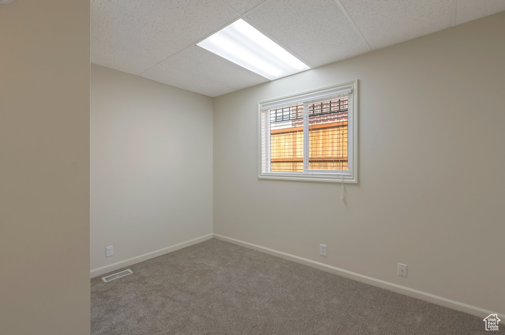 Empty room featuring carpet floors and baseboards