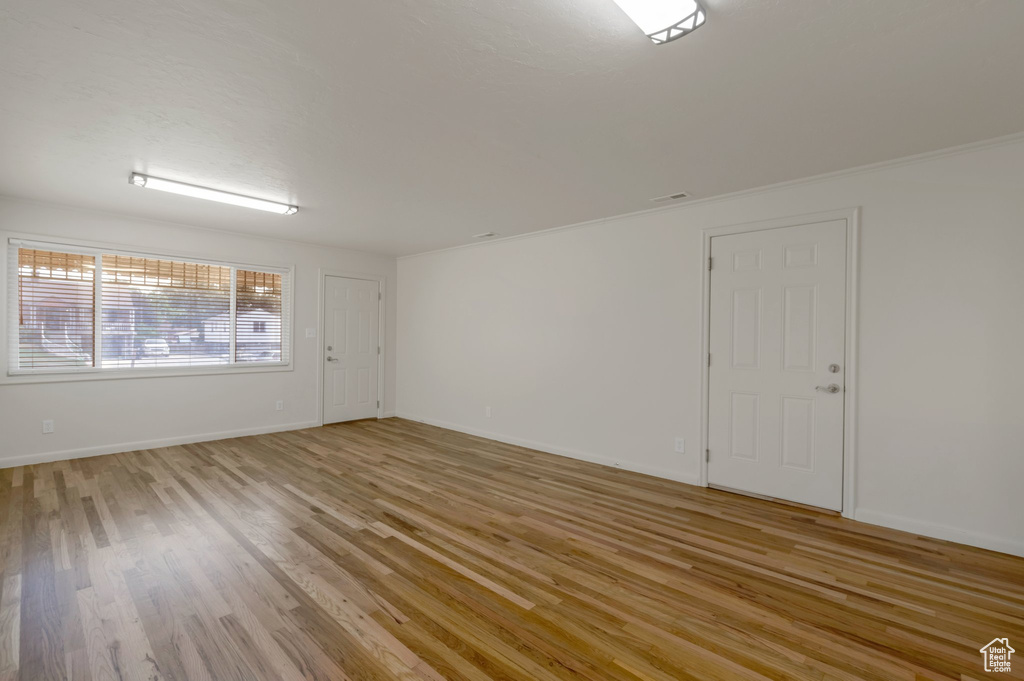 Empty room featuring light wood finished floors and baseboards