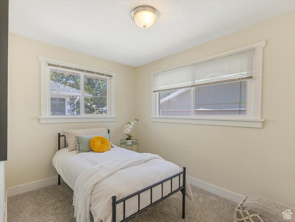 Carpeted bedroom featuring baseboards