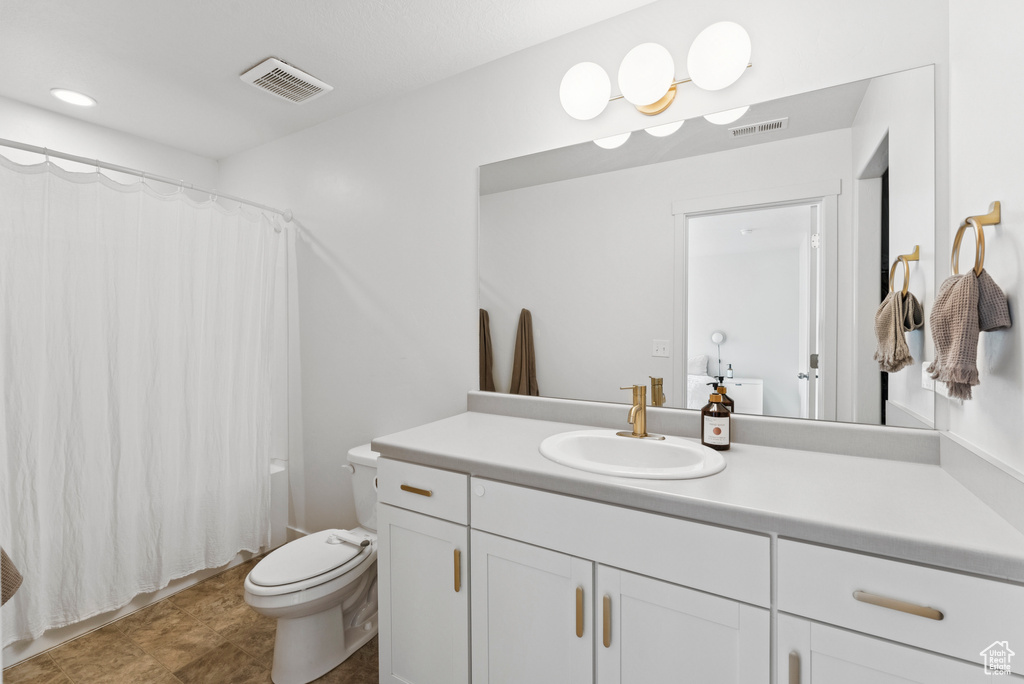 Bathroom featuring vanity and toilet