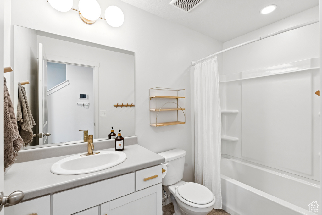 Bathroom featuring vanity and shower / tub combo with curtain