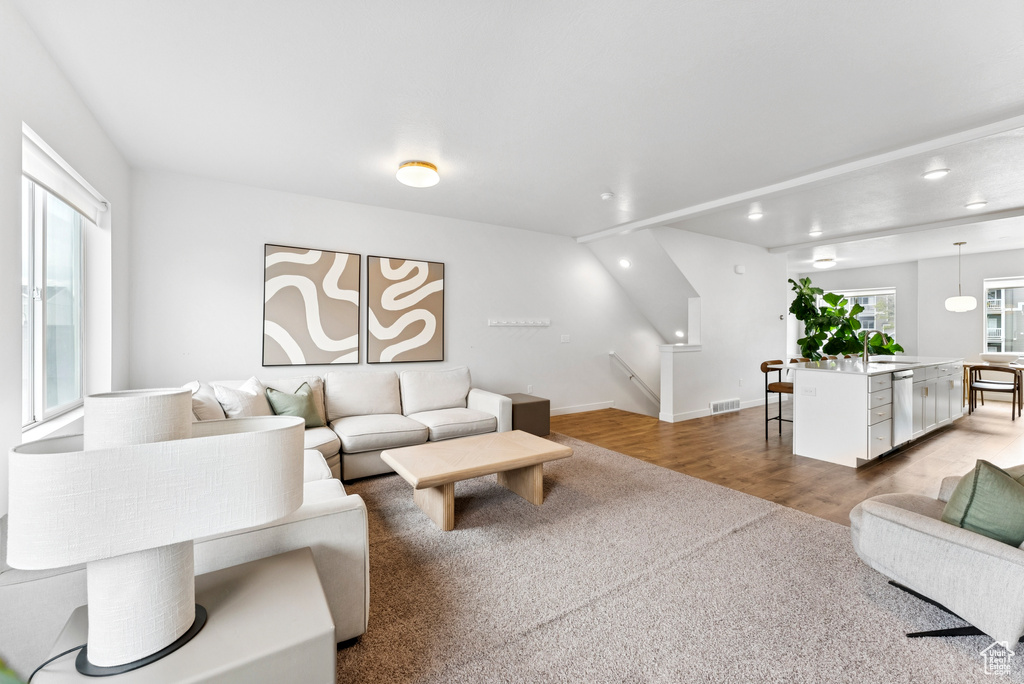 Living room with wood finished floors and recessed lighting