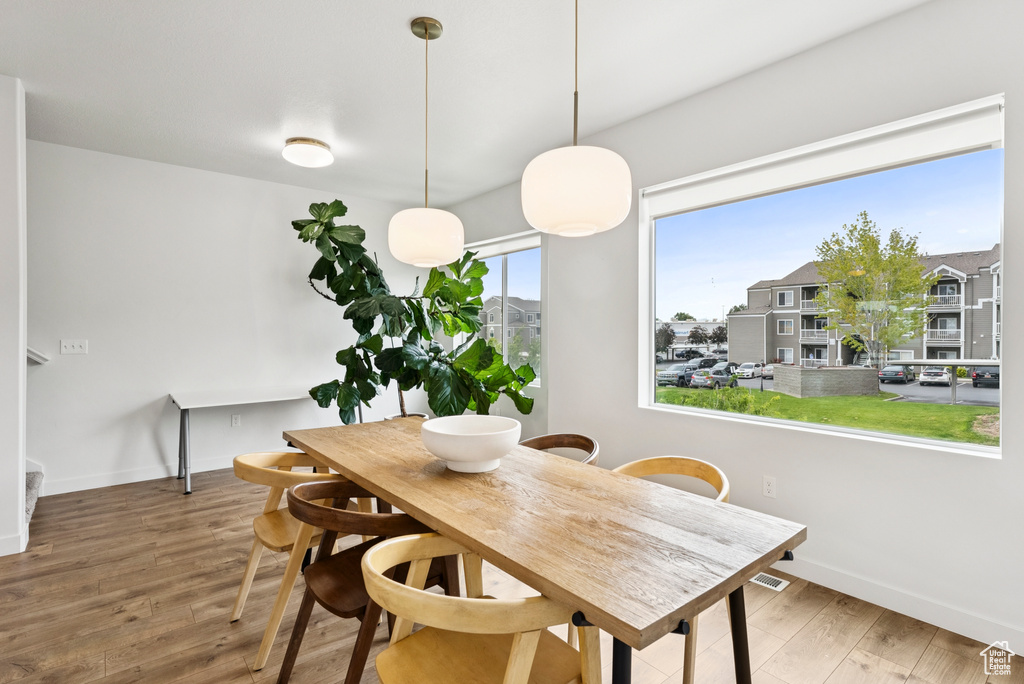 Dining room featuring wood finished floors and baseboards