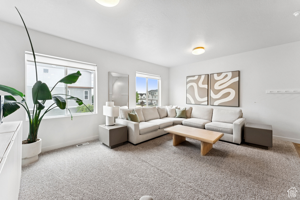 Carpeted living area featuring baseboards