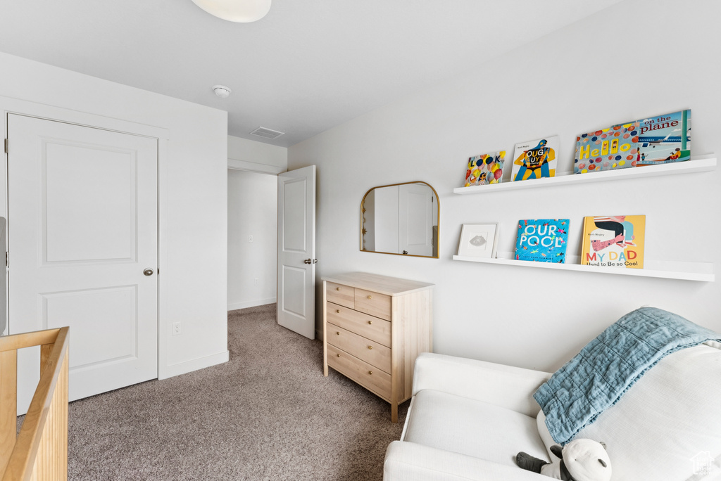 Sitting room with carpet floors and baseboards