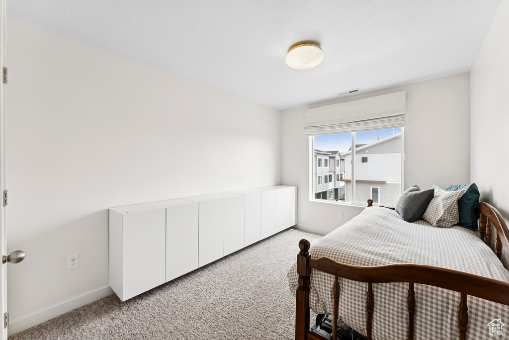 Carpeted bedroom with baseboards