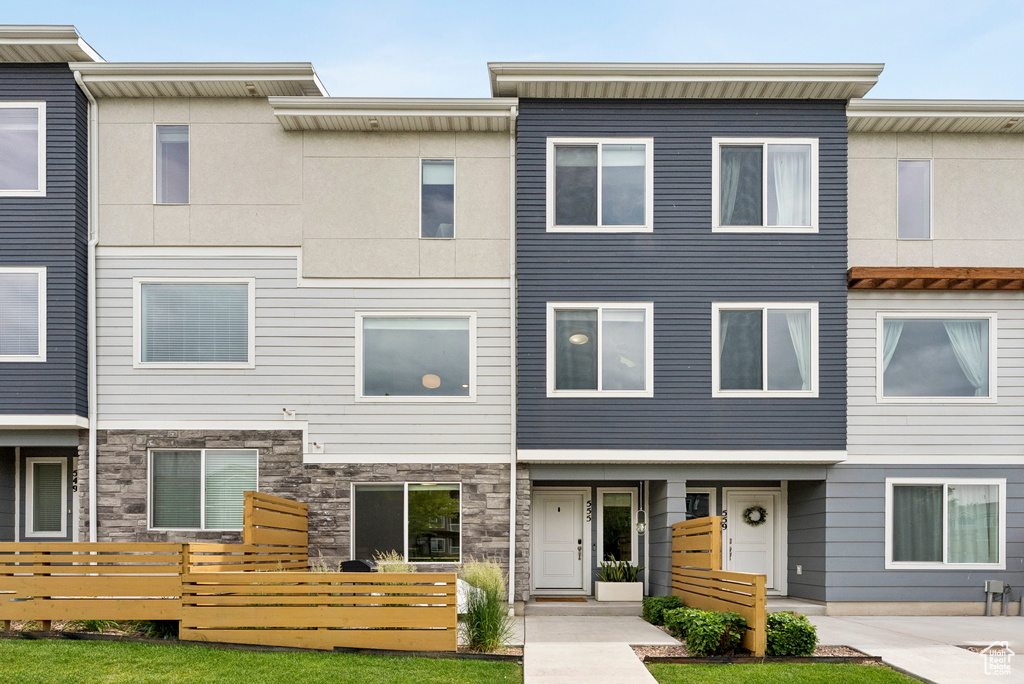 View of property with stone siding
