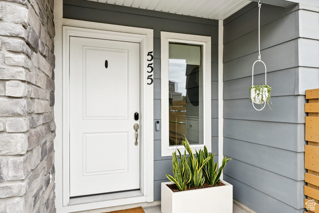 Doorway to property with stone siding