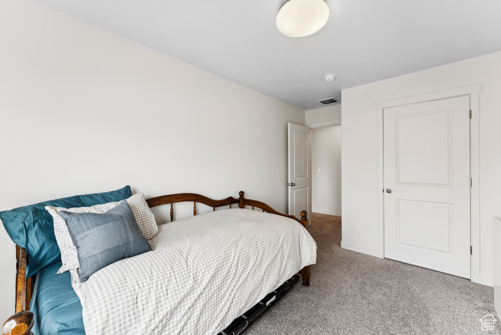 Bedroom featuring carpet floors and baseboards