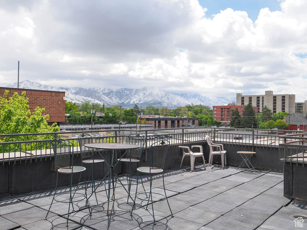 View of patio featuring a mountain view and a balcony