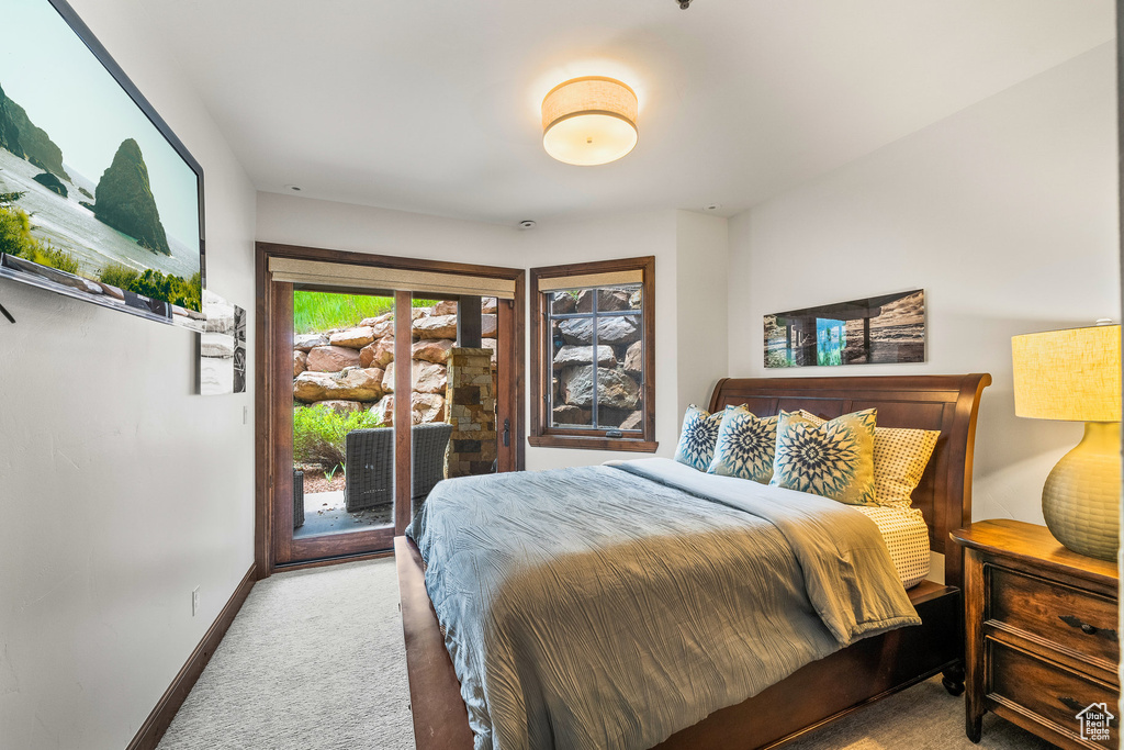 Bedroom featuring carpet flooring and access to exterior