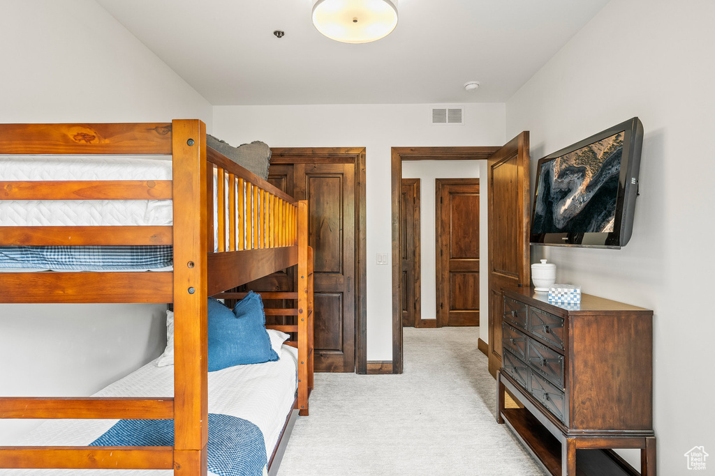 Bedroom with light carpet and baseboards