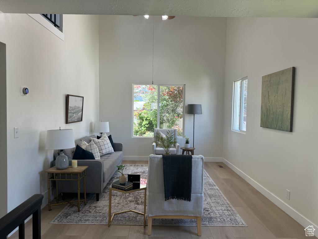 Living room with a towering ceiling and wood finished floors